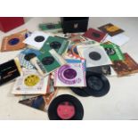 A collection of vinyl records 45 RPM the Beatles, Shirley Bassey, the Everly Brothers, The Monkees