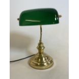 A modern library or bankers style lamp with green glass tilting shade and gilt metal base. H:37cm