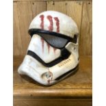 A Star Wars Stormtrooper helmet with painted blood and dirt effect. Plastic two piece construction