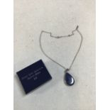 A silver and lapis pendant on a silver chain