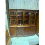 A large reproduction regency style break front mahogany bookcase. With glazed doors to display