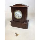 A wooden mantle clock with key W:30cm x D:15cm x H:38cm also with a round glass topped table