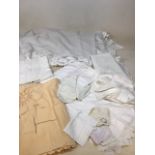 A quantity of house hold linen including tablecloths, napkins, runners, doilies and other items