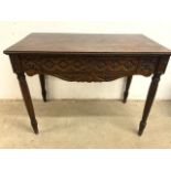 An 18th century style carved serving table with tapered legs and large central drawer. Carved