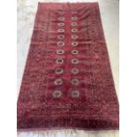 An attractive antique Afghan Turkoman rug with twenty two medallions surround by multiple borders.