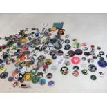 A tin of pin badges from 1970s/1980s including pop bands and others. David Bowie, Ramones, Sex