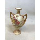 A Royal Worcester hand painted twin handled vase hand decorated to front and back with floral