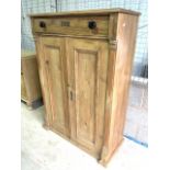 An antique pine two door cupboard with three internal shelves with drawer above. W:93cm x D:42cm x