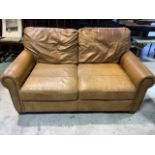 A two seater tan coloured leather sofa with stud detail to arms. W:155cm x D:100cm x H:85cm