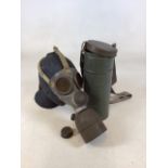 A military gas mask and tin holder