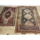 An antique Persian distressed rug also with an antique Kurdish rug. Both rugs with repairs and