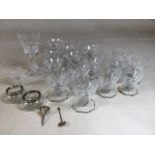 A quantity of glasses on octagonal base one marked VSL to base also with 2 Waterford glasses and a