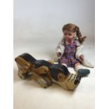 A vintage wooden push along dog also with a vintage doll