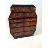 A twentieth century Meiji style parquetry and lacquered wood table cabinet with 8 drawers over 1.