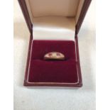 An 18 carat gold ring set with ruby and white stone. Size K/L. Total weight 3gm. Box not included