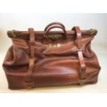 Large leather Gladstone bag with compartment to base. Heavy brass fittings with original key.