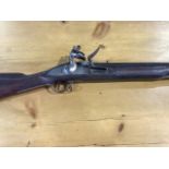 An early 19th century English Brown Bess flintlock musket with bayonet. With flint. Lock marked