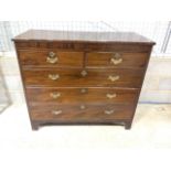 A large late 19th early 20th century mahogany chest of drawers with two short over three long