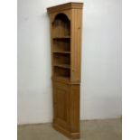 A solid pine two piece corner cupboard with three shaped shelves above cupboard with internal shelf.