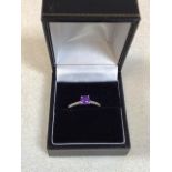 A 9 carat white gold amethyst and diamond ring. Size N/O.