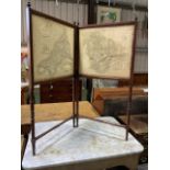 A Victorian two fold turned mahogany map screen. With maps of Devonshire and Cornwall. John Cary