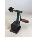 A vintage coconut shredder on stand H:22cm