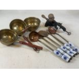 A vintage kitchelia lot, ceramic handled brass and copper utensils, graduated brass drainers also