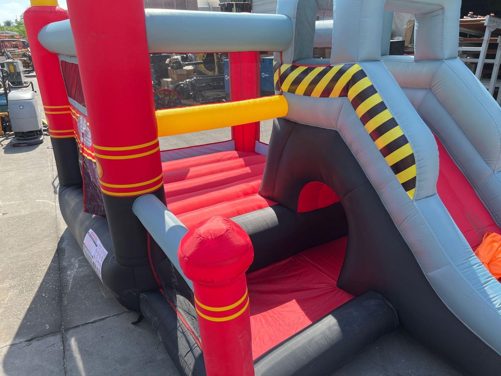 UNUSED BLOW-UP BOUNCY FIRE STATION PLAY YARD WITH SLIDE, VELCRO DARTS, BALLS, STAKES, & BLOWER - Image 2 of 12