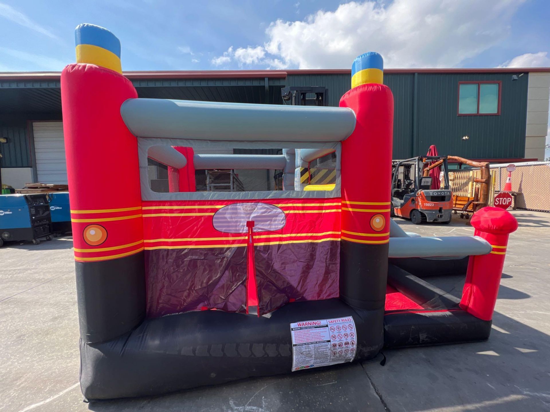 UNUSED BLOW-UP BOUNCY FIRE STATION PLAY YARD WITH SLIDE, VELCRO DARTS, BALLS, STAKES, & BLOWER - Image 9 of 12