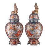 A pair of Japanese Imari covered vases, on a porcelain base, early Meiji, Total H 82,5 cm