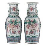A pair of Chinese famille rose vases with a battle scene, paired with handles of recumbent lions, 19