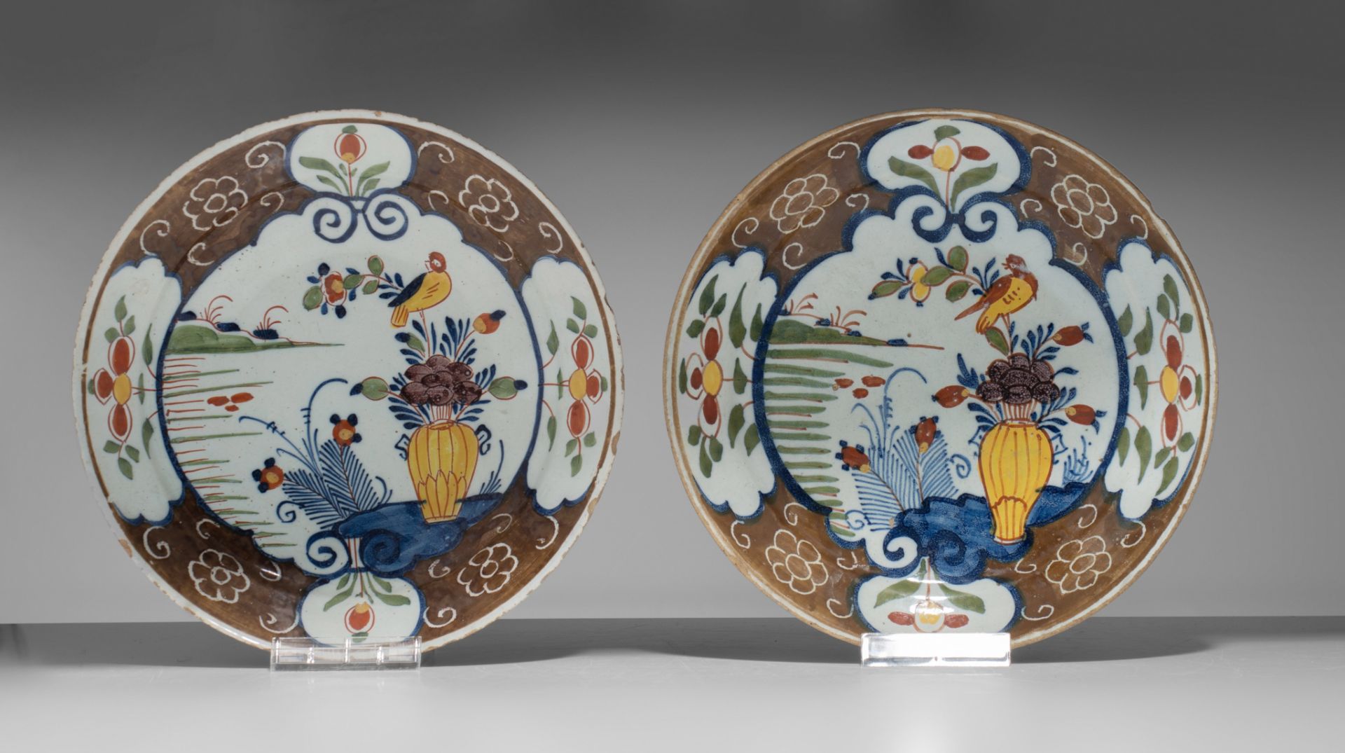 A various collection of thirteen 18thC Delft chargers and plates, ø 22 - 34,5 cm - Image 8 of 17