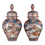 A similar pair of large Japanse Imari 'Crane' vases and covers, Edo period, late 18thC, H 64,5 cm