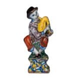 An 18thC Dutch Delft polychrome decorated figurine of a bagpiper, H 12,5 cm