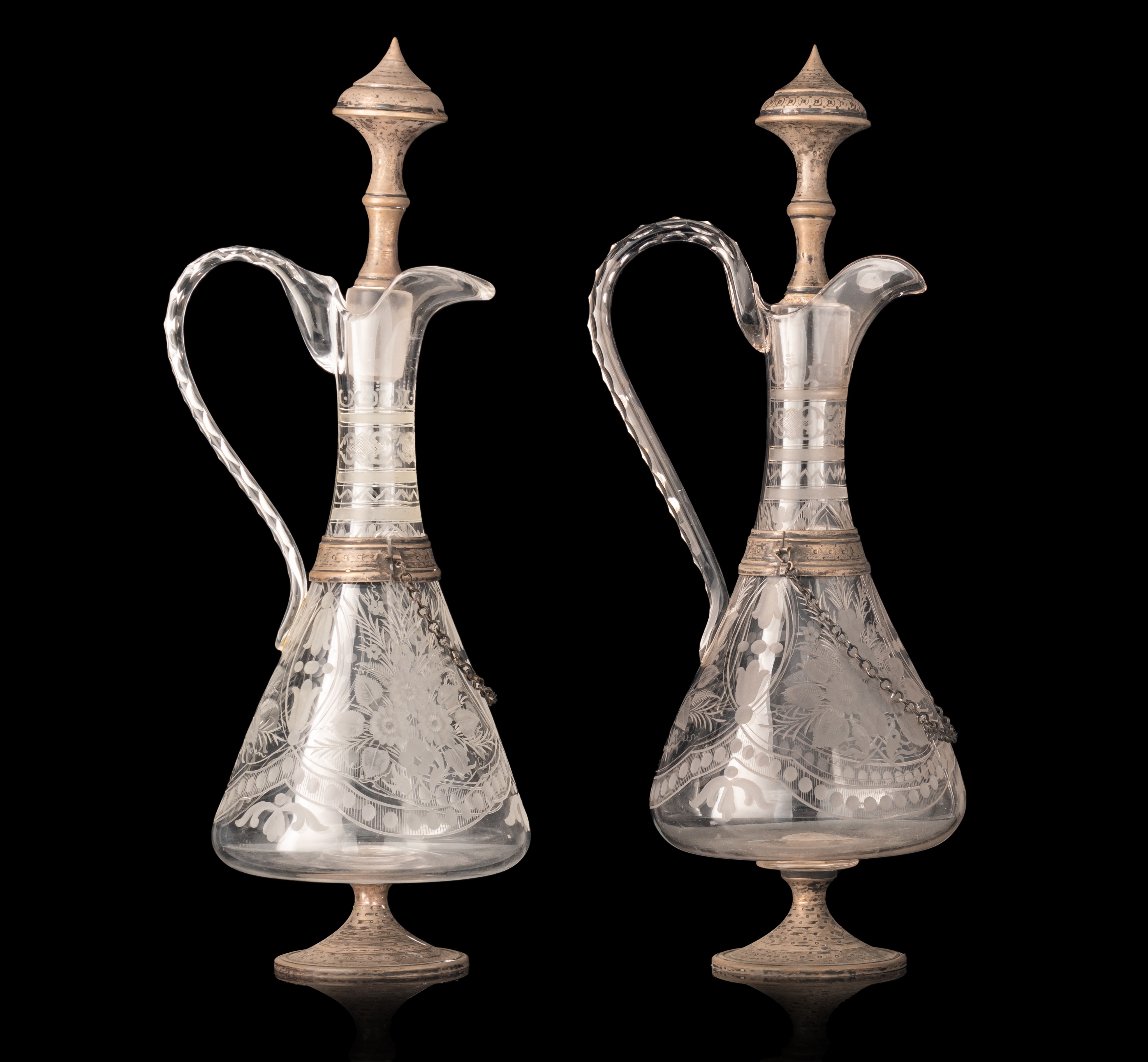 A pair of glass, silver-plated brass mounted decanters, H 41 - 42 cm