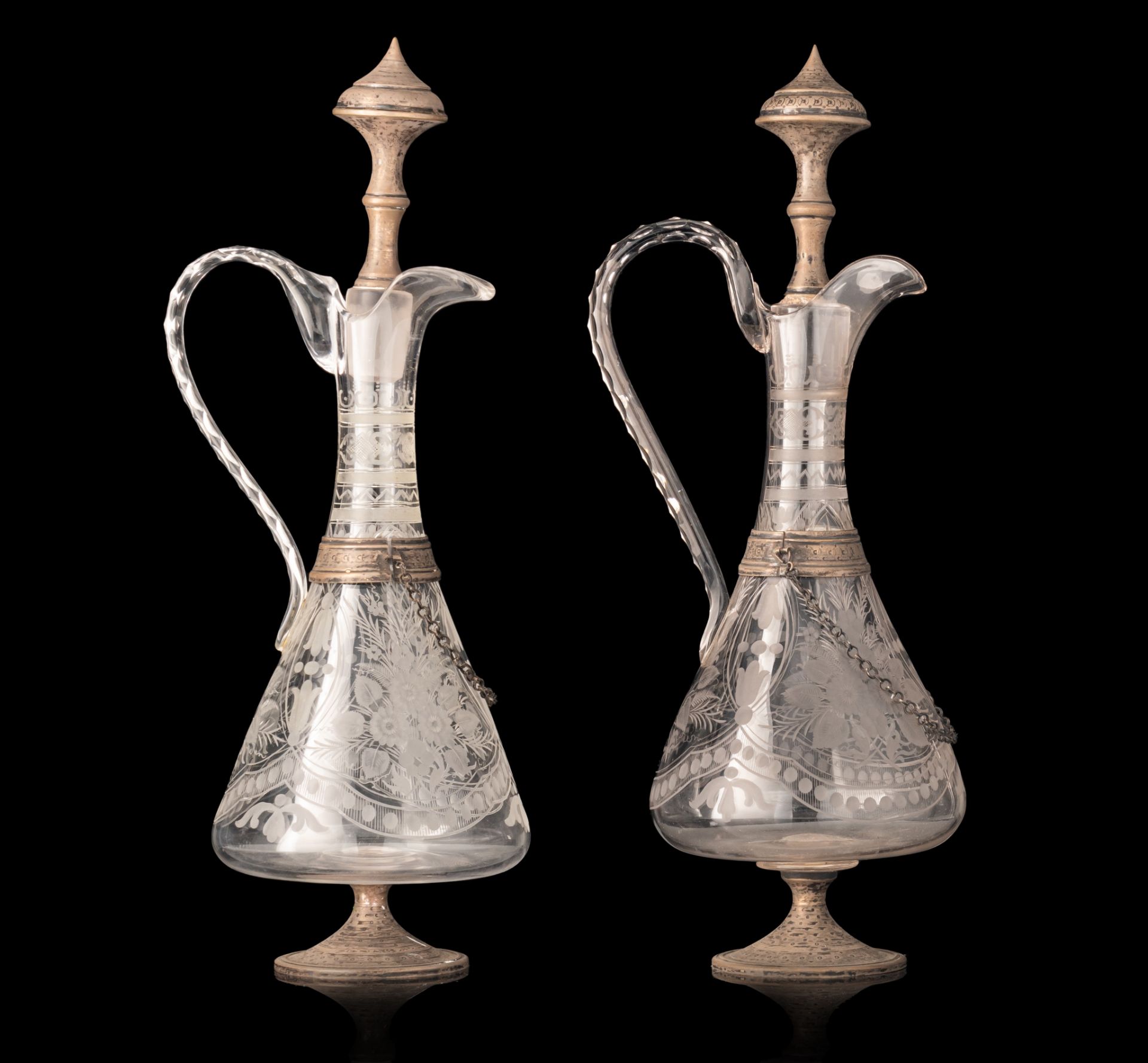 A pair of glass, silver-plated brass mounted decanters, H 41 - 42 cm