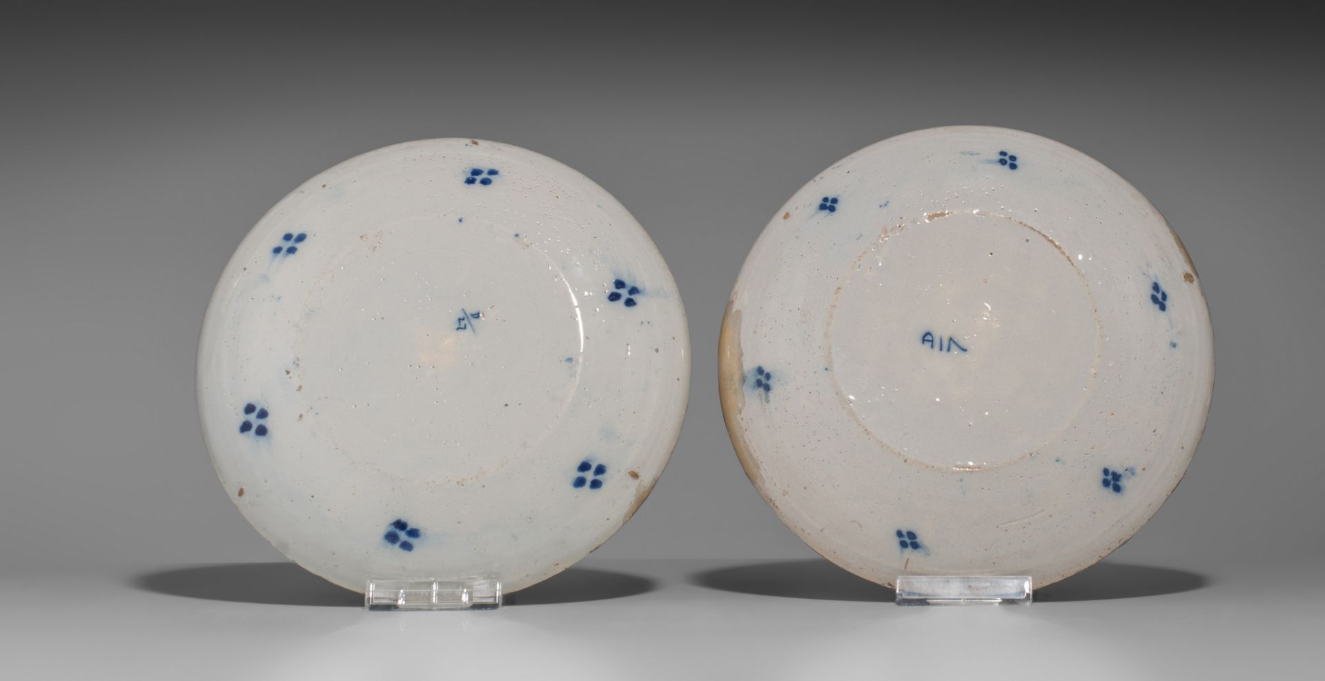 A various collection of thirteen 18thC Delft chargers and plates, ø 22 - 34,5 cm - Image 7 of 17