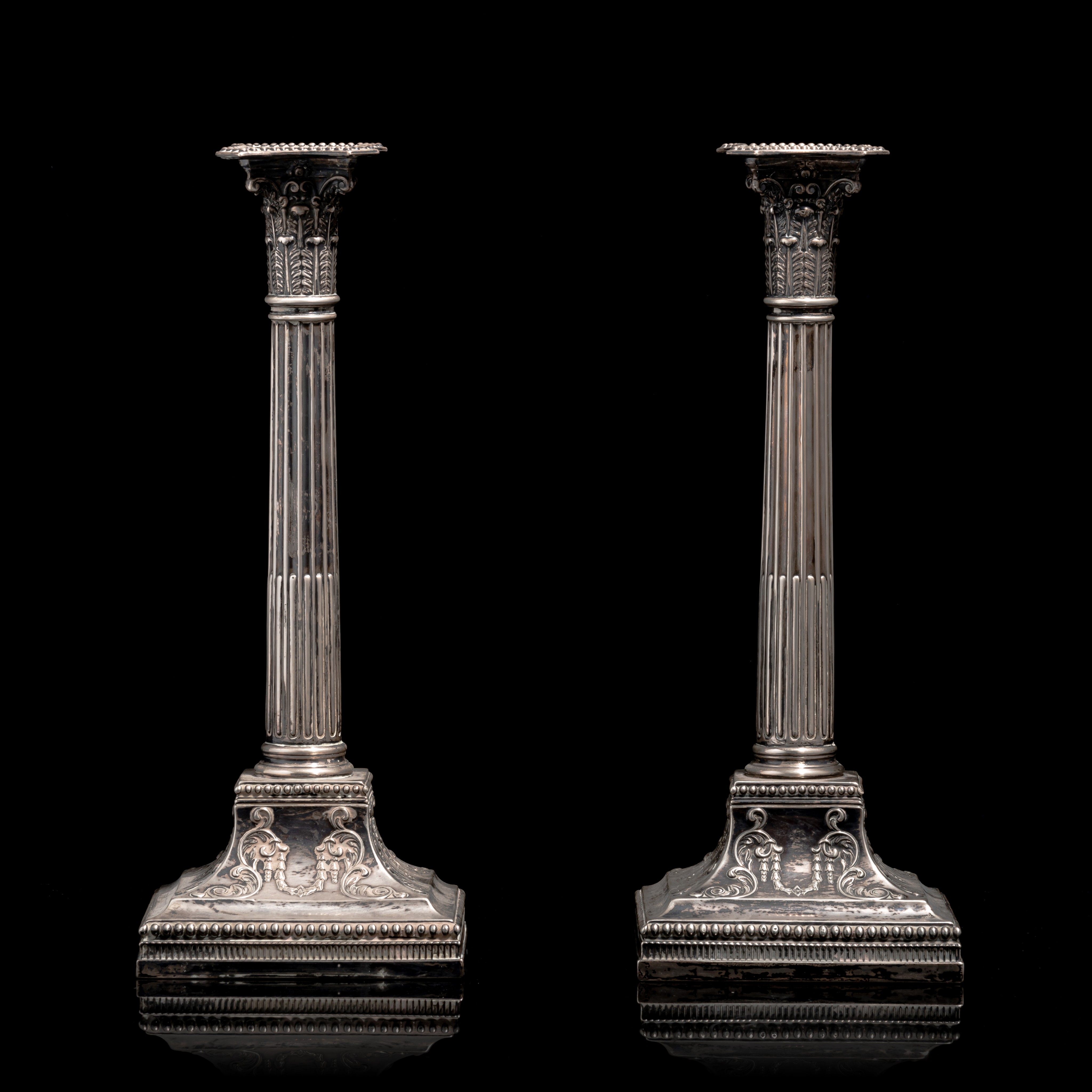 A pair of English sterling silver Neoclassical column-shaped candlesticks, hallmarked Sheffield, H 3