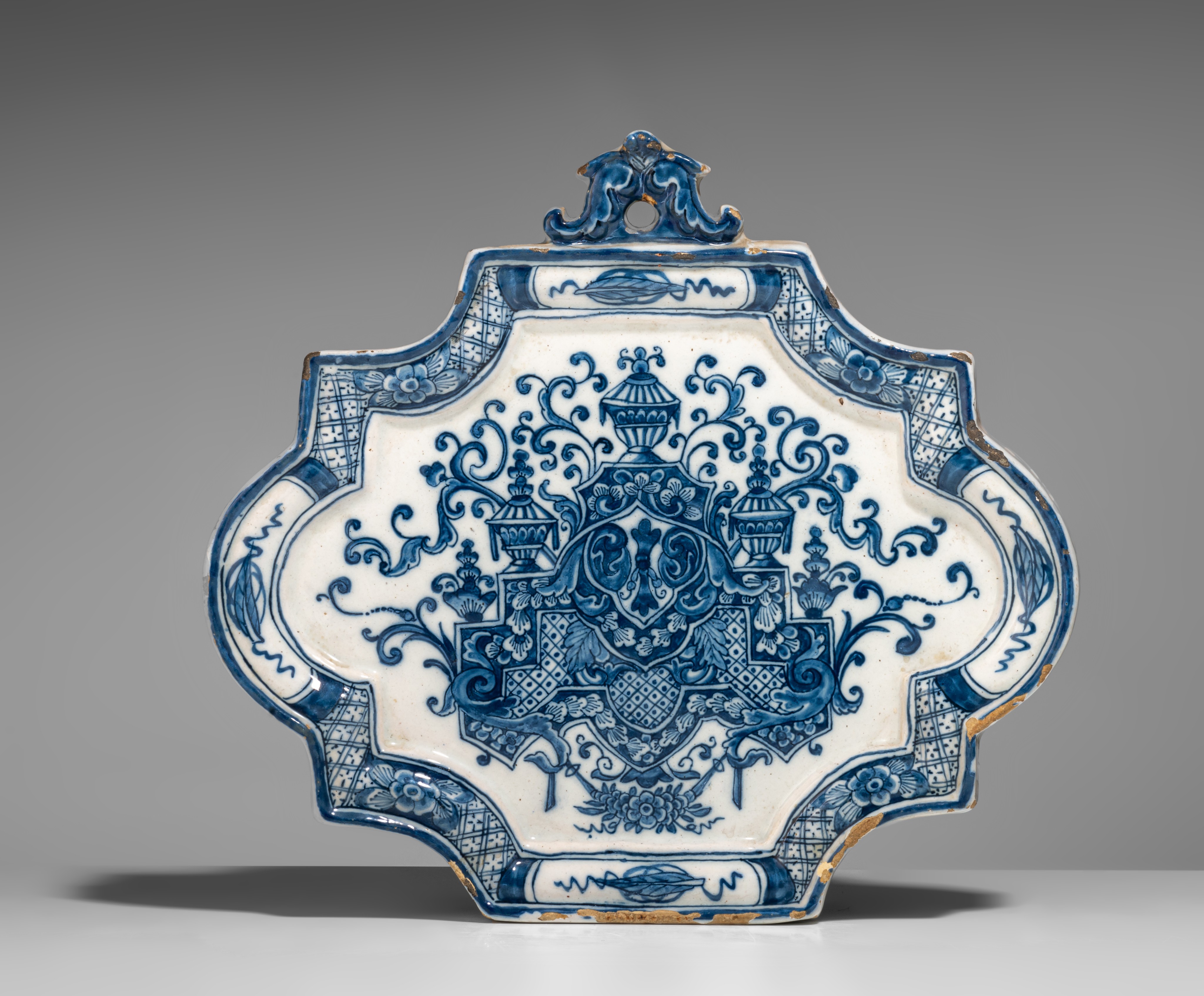 An 18thC Dutch Delft blue and white decorated plaque with a central lambrequin, H 22 cm - Image 2 of 3