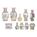 A collection of Chinese famille rose vases and a jardinirère, multiple pairs, some with a text, 20th