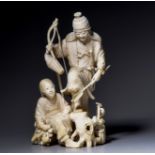 A Japanese ivory animated group of a hunter with his daughter, H 18,7 cm, 570 g (+)