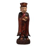A Vietnamese lacquered wooden figure of a standing monk, on a lotus base, Total H 82,5 cm