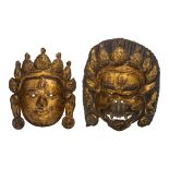 A Sino-Tibetan gilt bronze mask of Bodhisattva and one of a wrathful deity, 20thC, largest 32 x 26 c