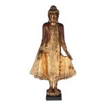 A Burmese gilt lacquered wooden figure of standing Buddha, inlaid with glass beads, 19thC, H 103,5 c