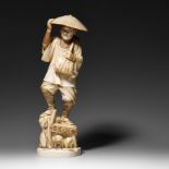 A Japanese ivory okimono of a jolly farmer, late Meiji period, H 30,5 cm, 1405 g (+)