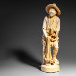 A Japanese ivory okimono of a fisherman, Shôwa period, H 37,5 cm, 2304 g (+)