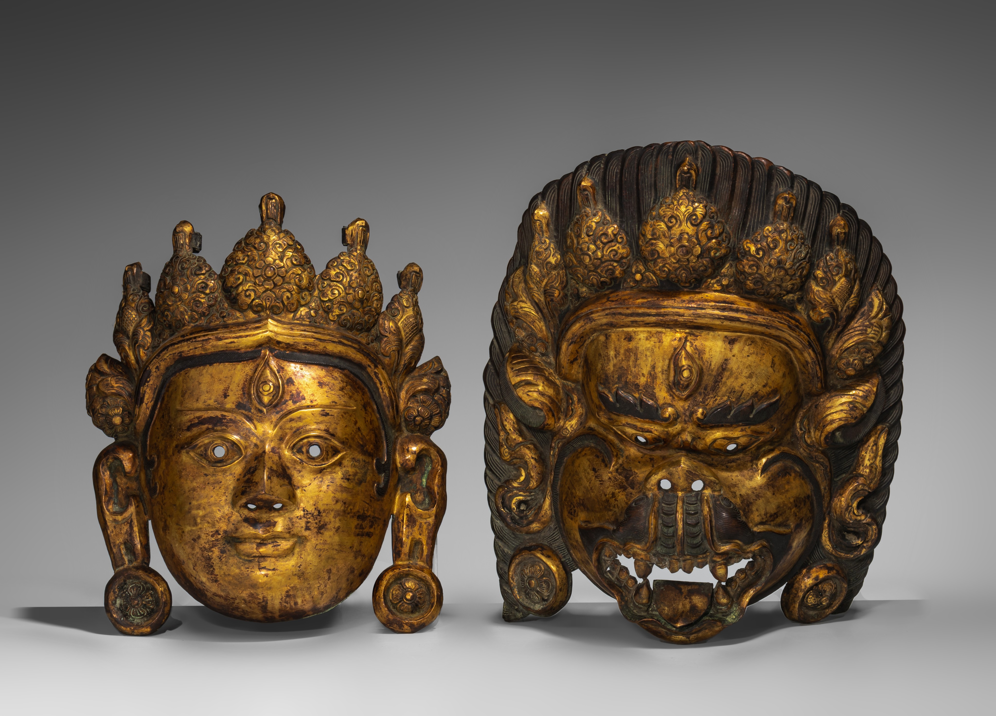 A Sino-Tibetan gilt bronze mask of Bodhisattva and one of a wrathful deity, 20thC, largest 32 x 26 c - Image 2 of 5