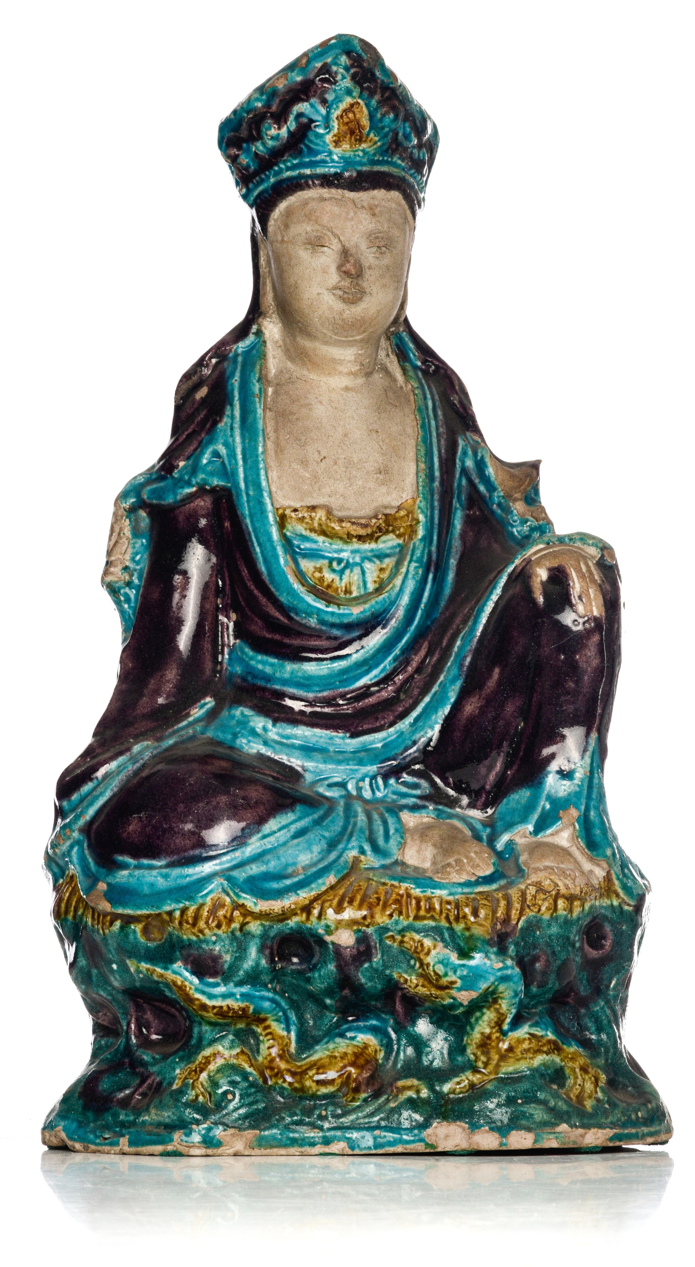 A Chinese Fahua-style glazed figure of a seated Guanyin, late Ming period, H 34,5 cm