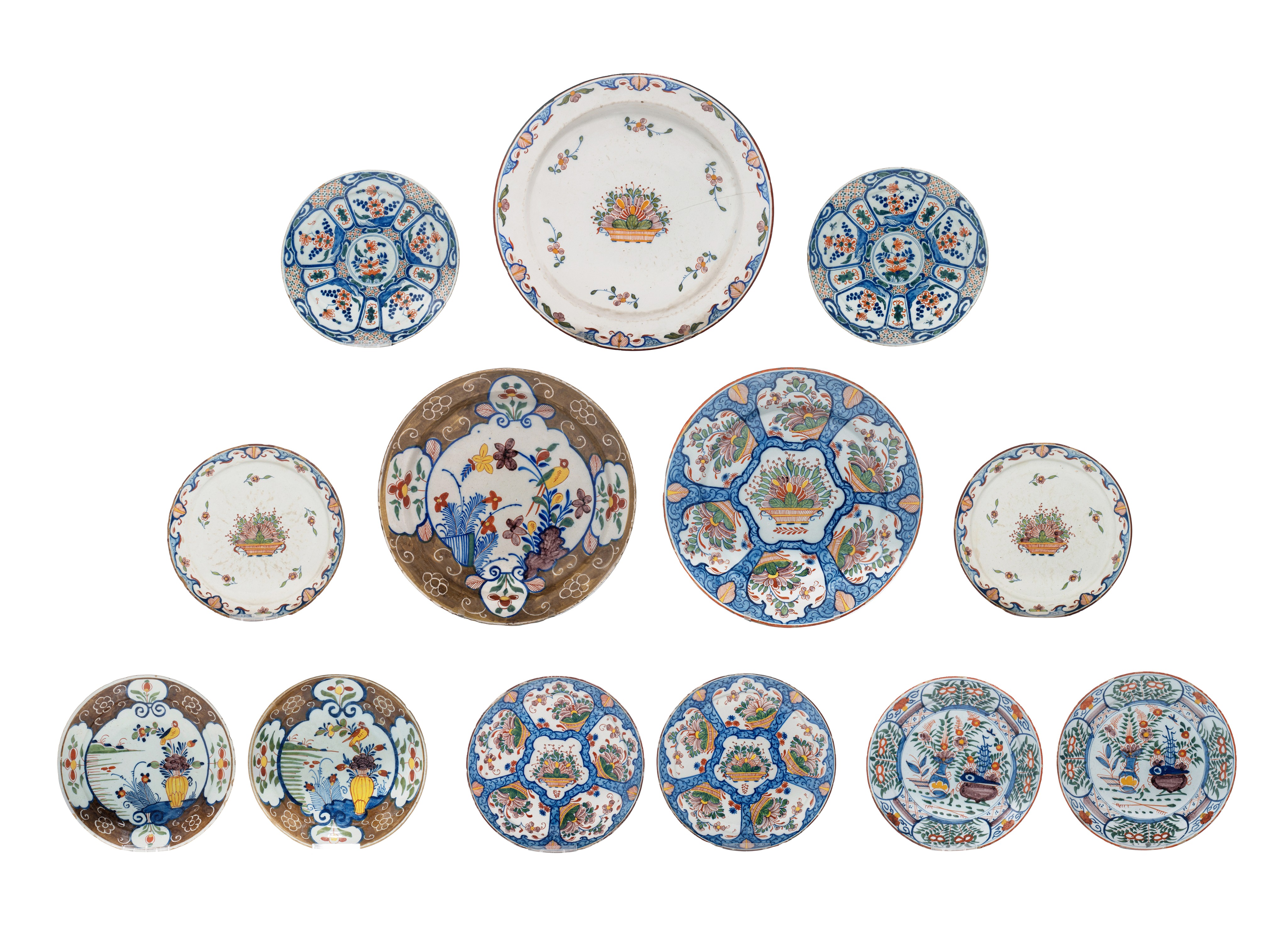 A various collection of thirteen 18thC Delft chargers and plates, ø 22 - 34,5 cm