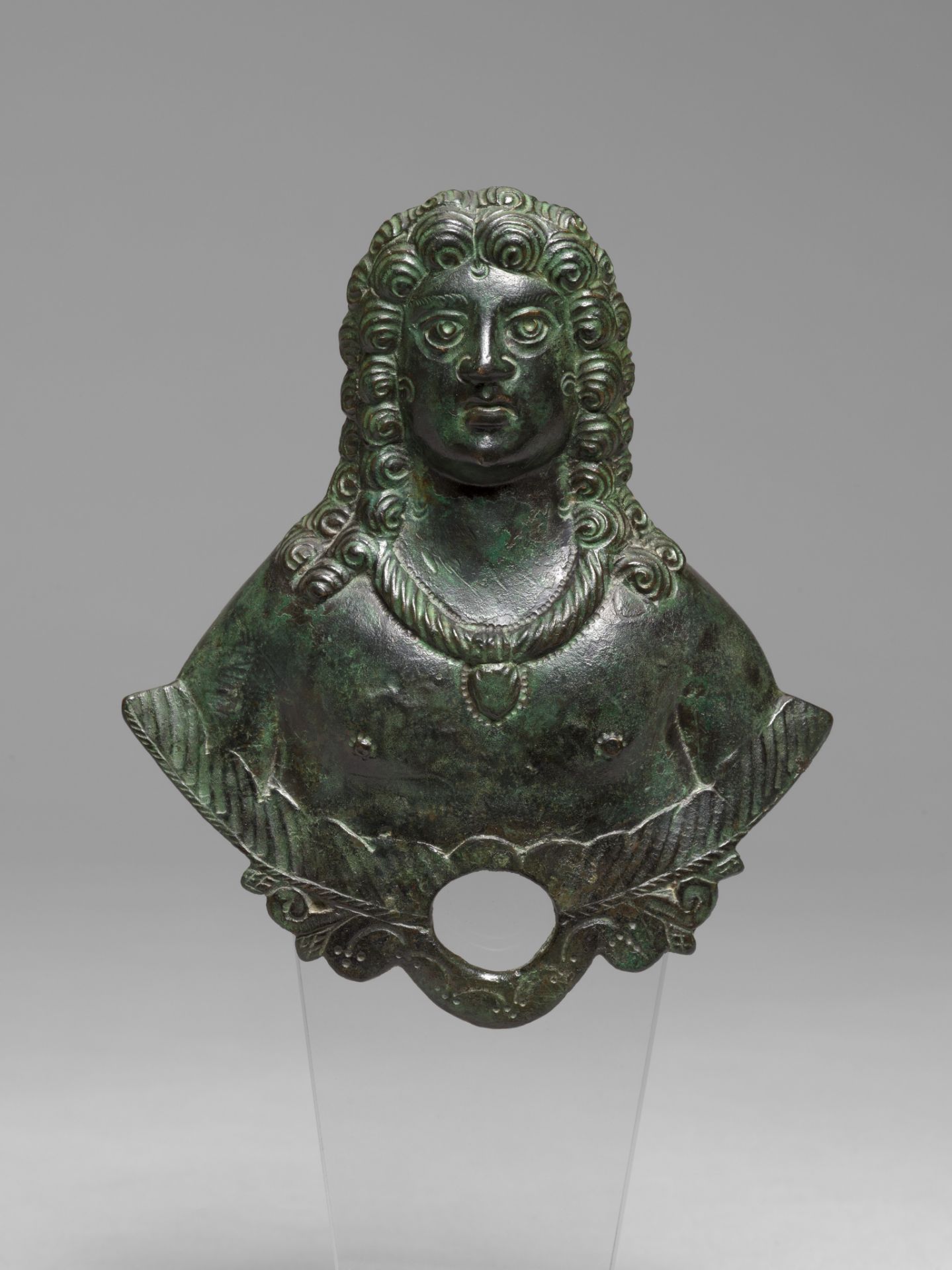 A green patinated bronze applique bust, Roman Empire, 3rd/4thC A.D., H 14,5 cm